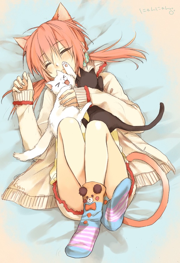 Cat boy laying down with cats